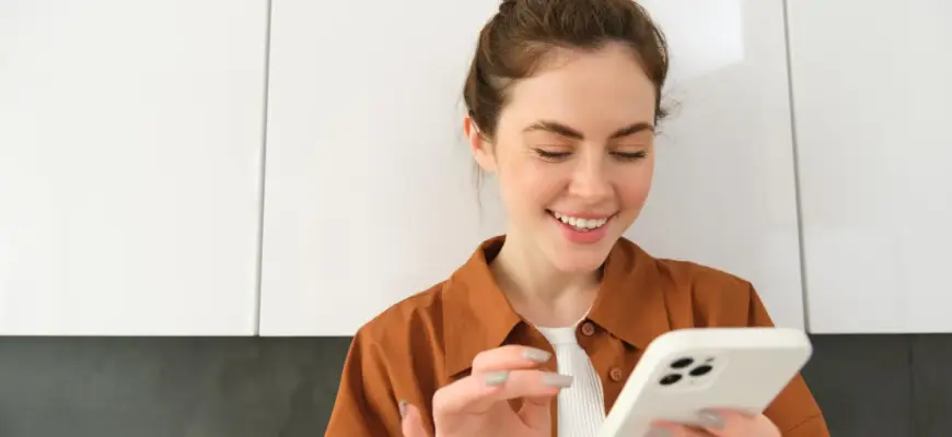 Девушка читает сообщение на телефоне — девушка отвечает односложно на сообщения